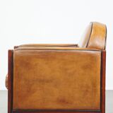 Sheep leather and wooden Art Deco design armchair with ball feet