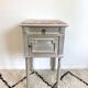 Grey patinated bedside table with marble top