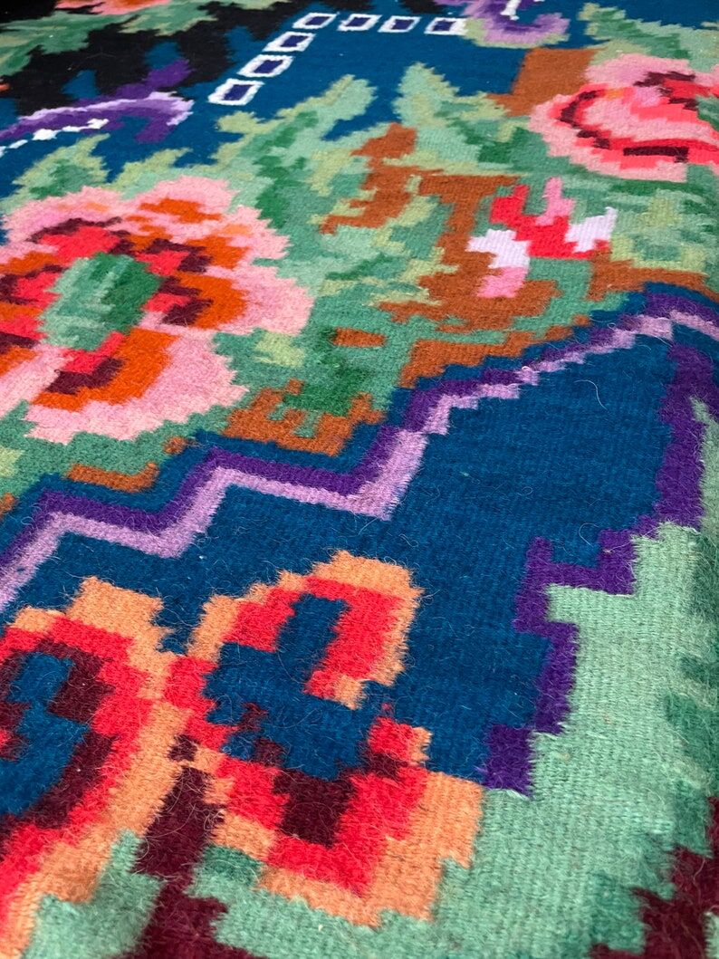 Rug with floral design on a blue background made by hand in Romania