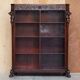 Hand-carved library circa 1900 in hardwood with Hermes statues.