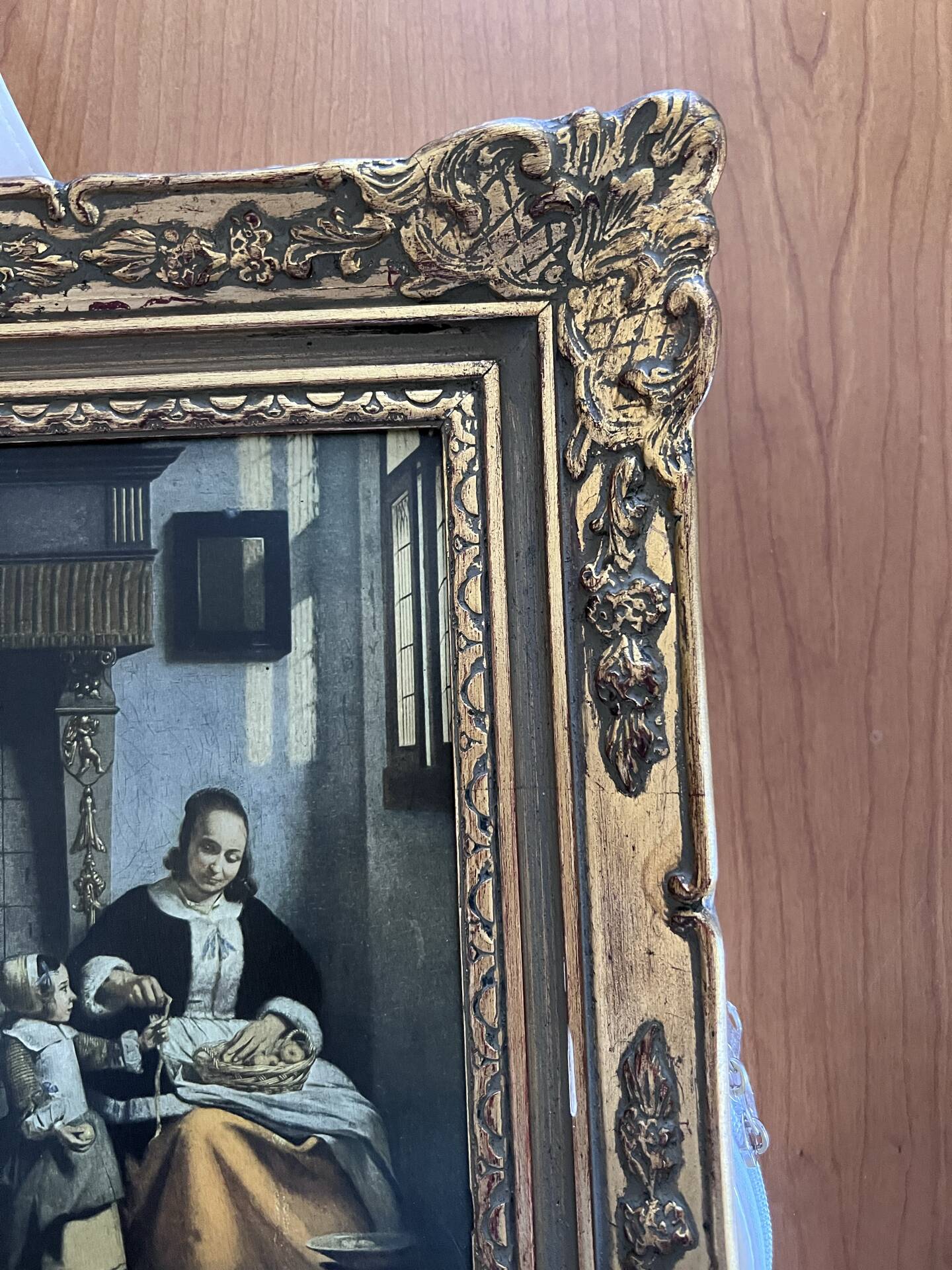 Framed reproduction painting with a golden frame.