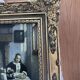 Framed reproduction painting with a golden frame.