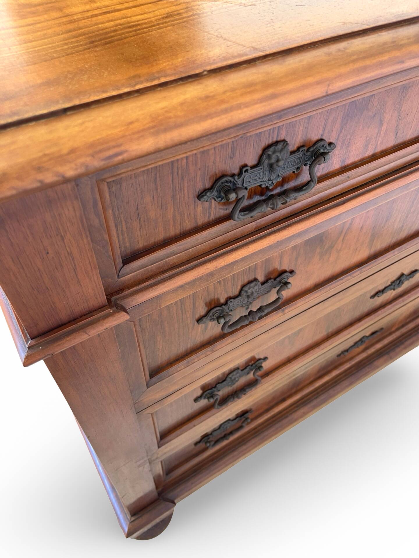Antique walnut commode with bronze handles in the shape of a lion's mask,