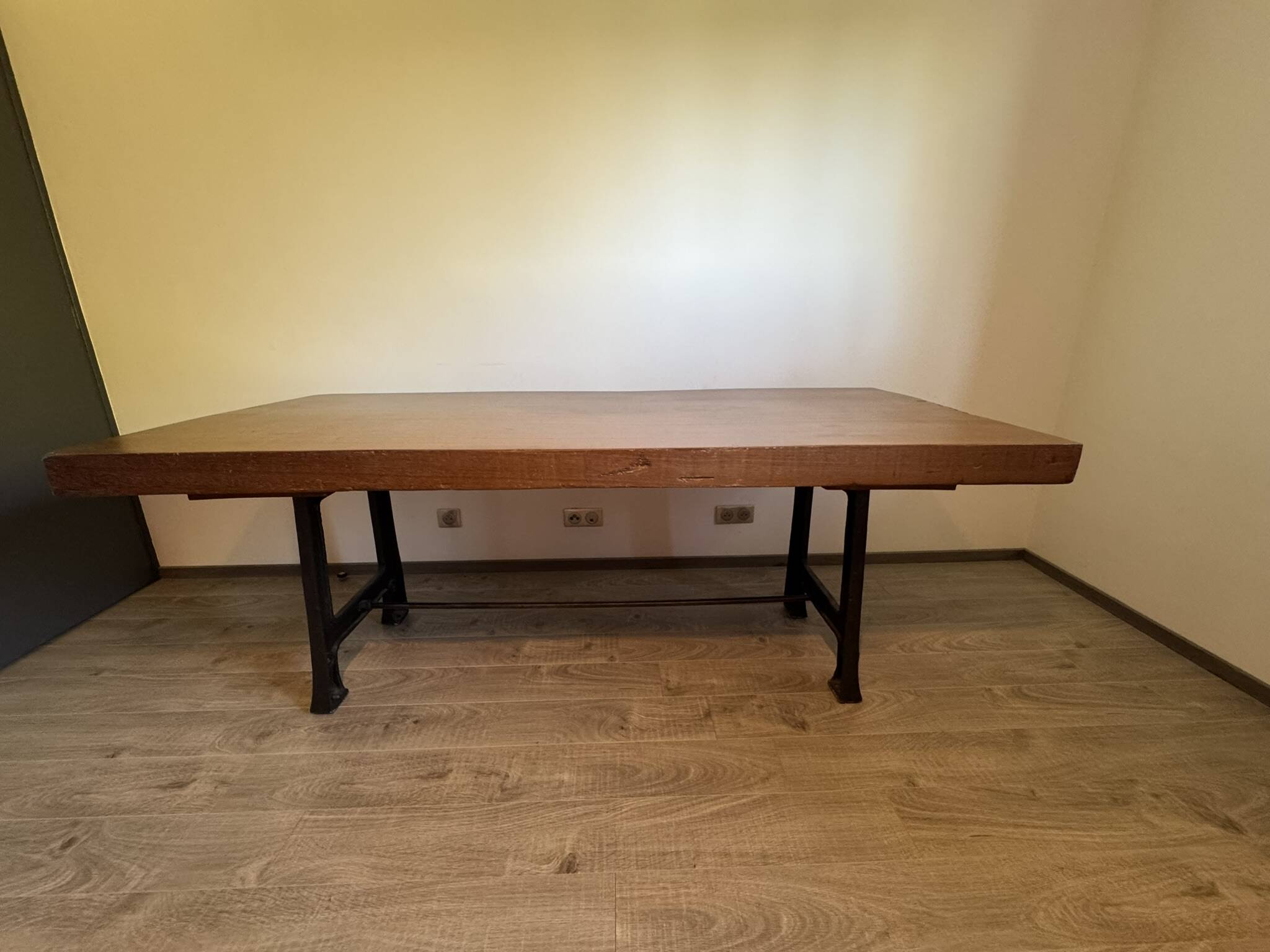 Industrial style table with a mahogany top.
