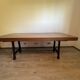 Industrial style table with a mahogany top.