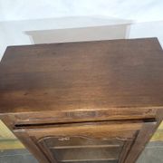 Small oak display cabinet with one door.