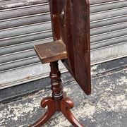 19th-century solid mahogany table with a tilting top and brass mechanism.