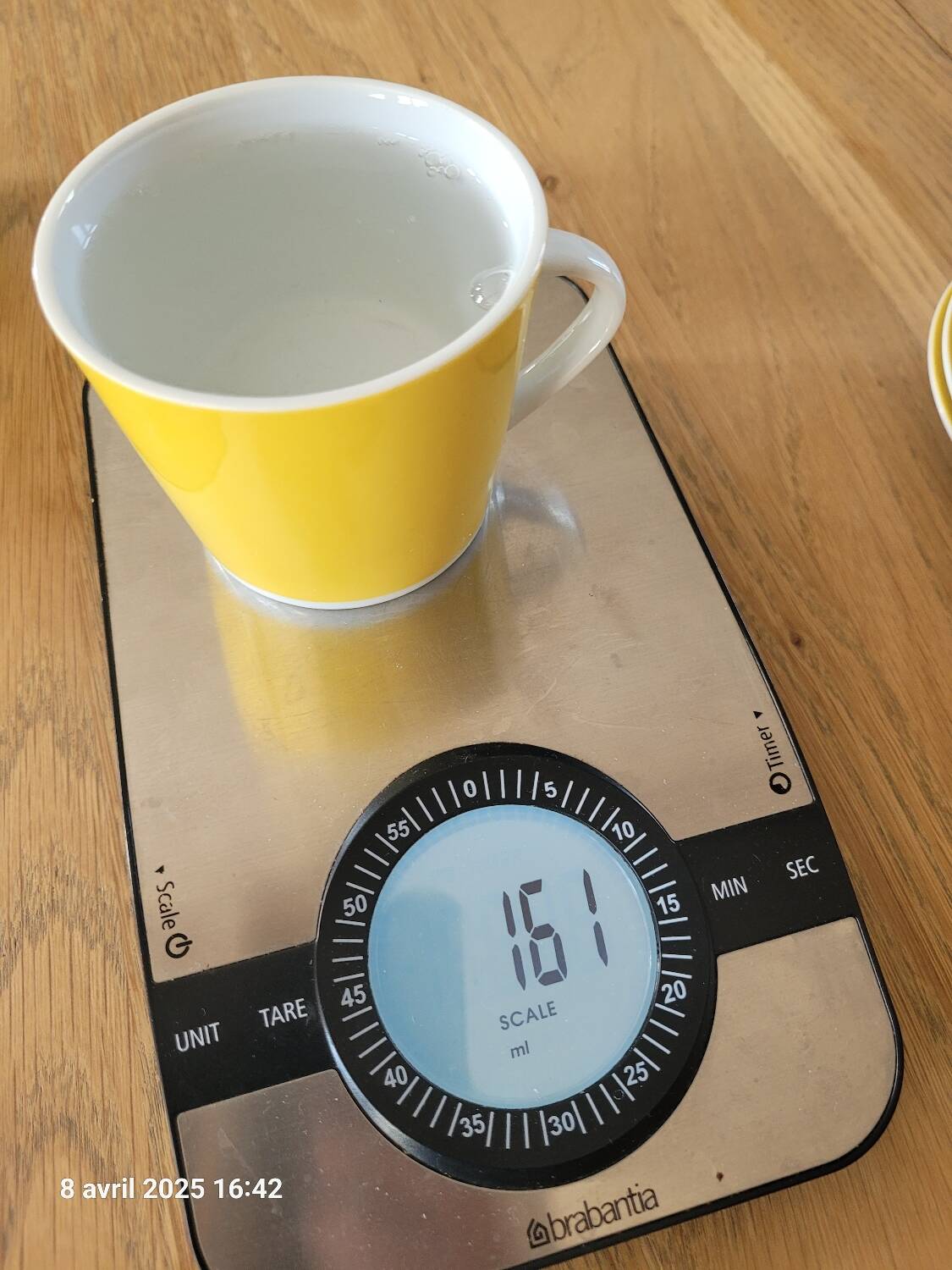 4 yellow and white cups and saucers