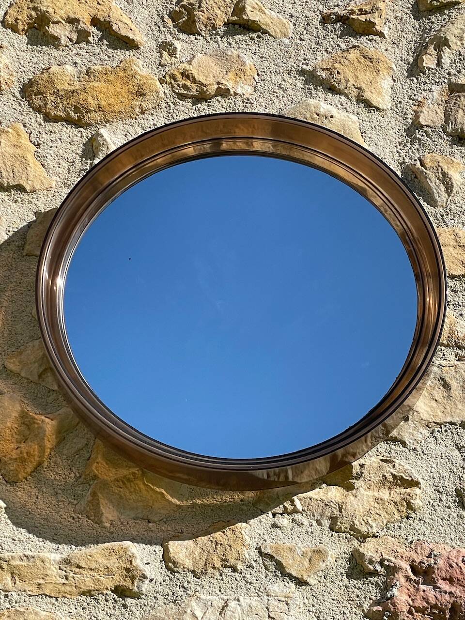 Vintage round smoked plastic mirror, circa 1970s.