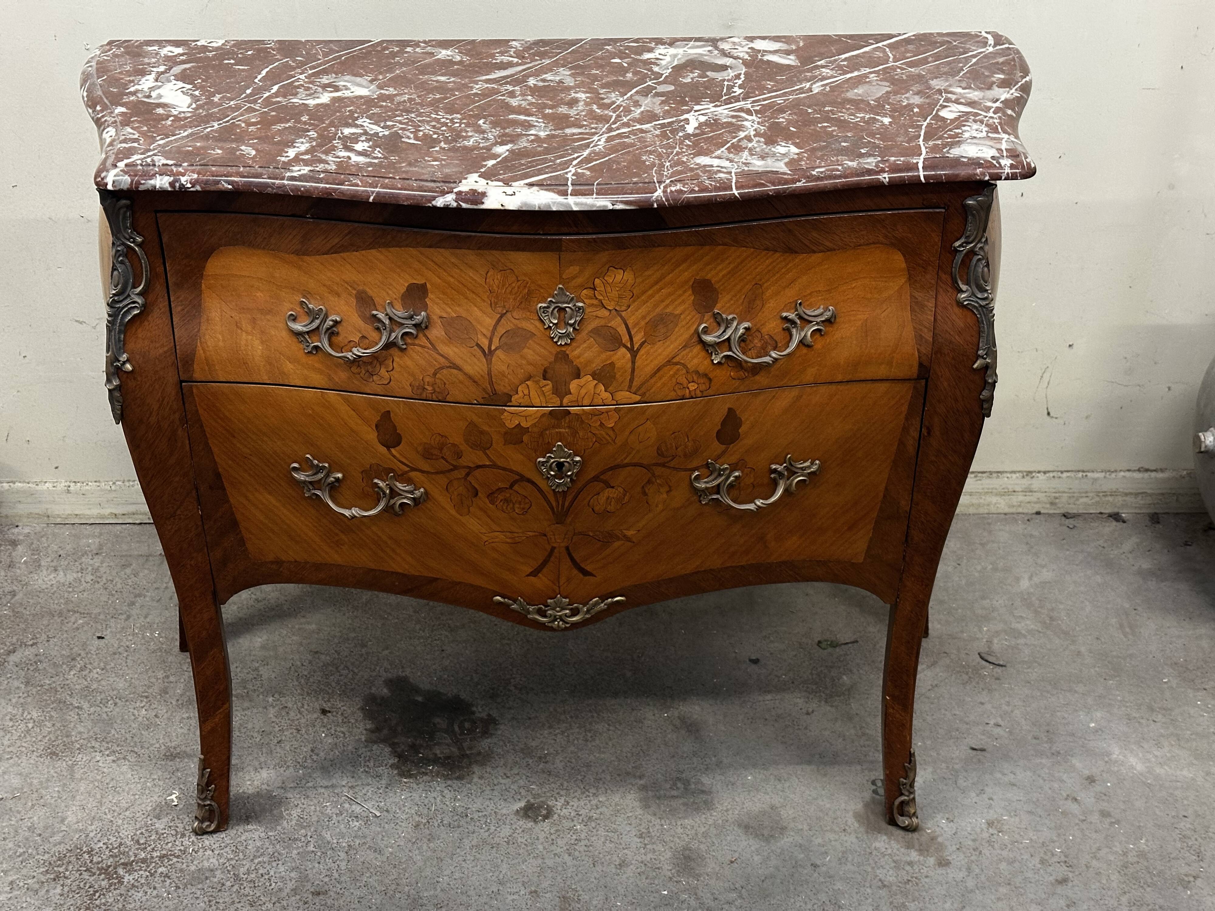 Curved and inlaid Louis XV style chest of drawers