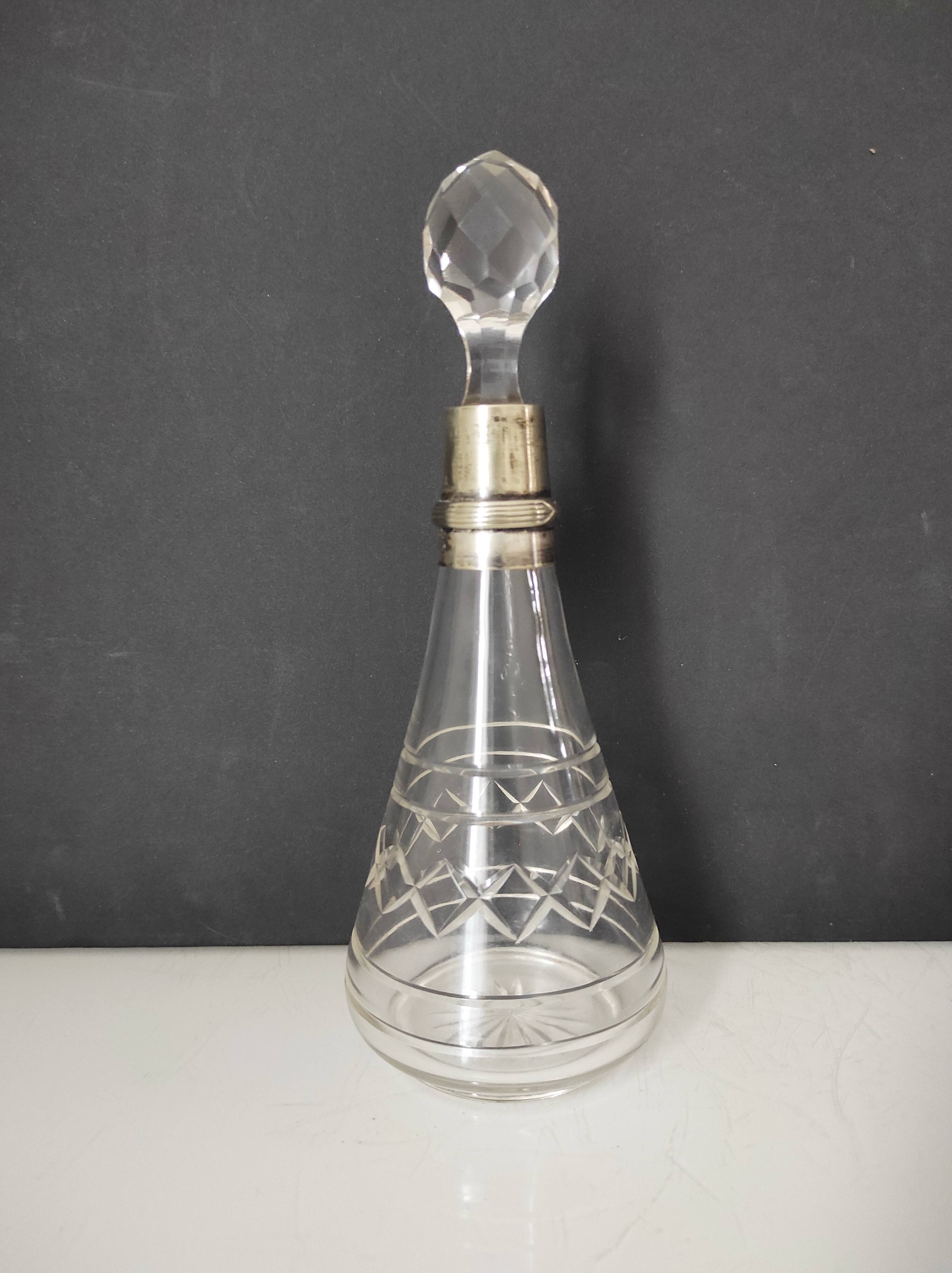 Crystal bottle with silver metal neck rim