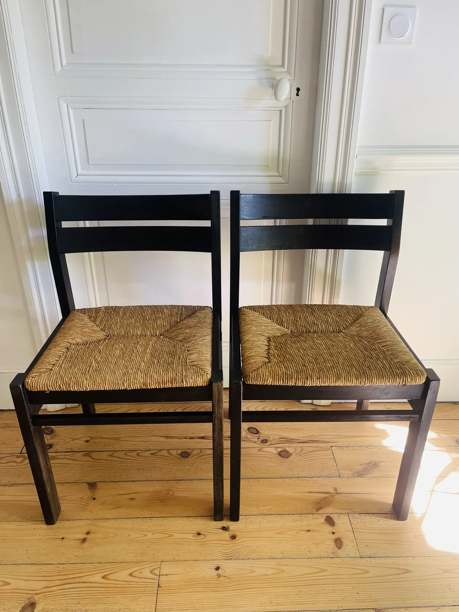 Pair of straw-seated wooden chairs in the regain style.