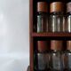 Wooden shelf with 32 vintage Cole & Mason spice jars