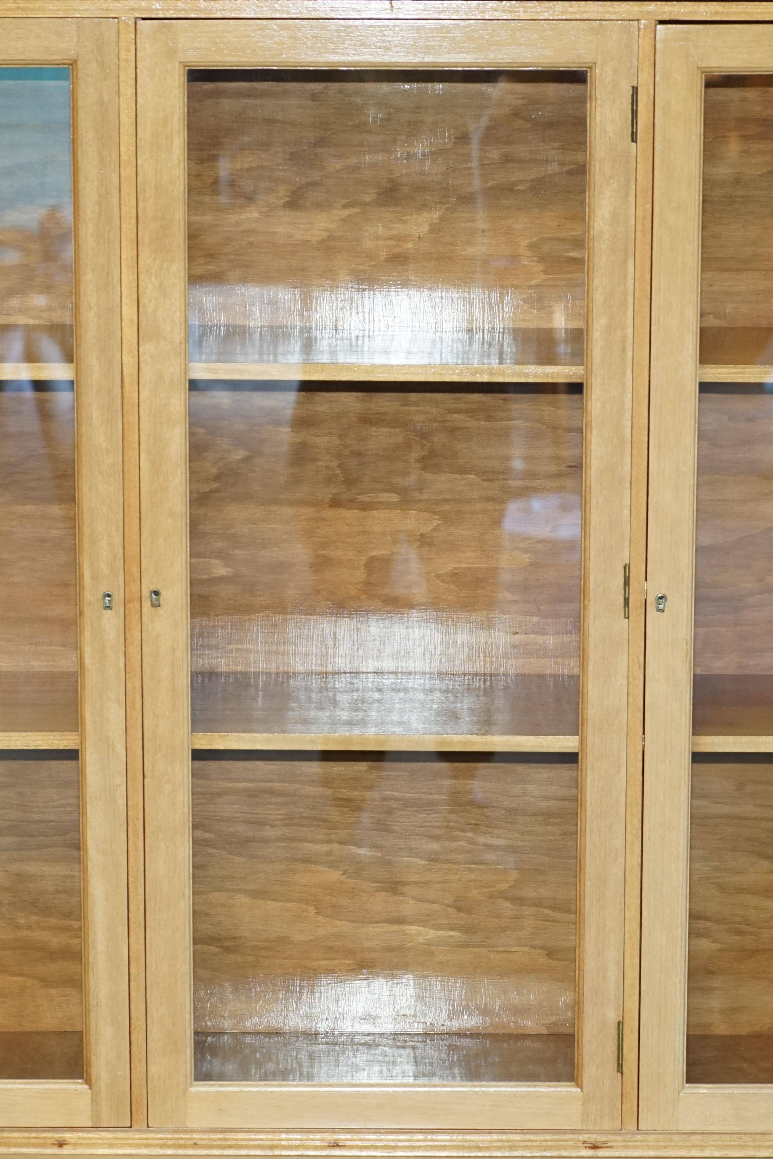 Library in the style of David Linley in satinwood, walnut, and rosewood.