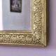 Rectangular wooden mirror with ornate Art Nouveau gold finish.