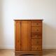 Vintage wooden storage cabinet with drawers