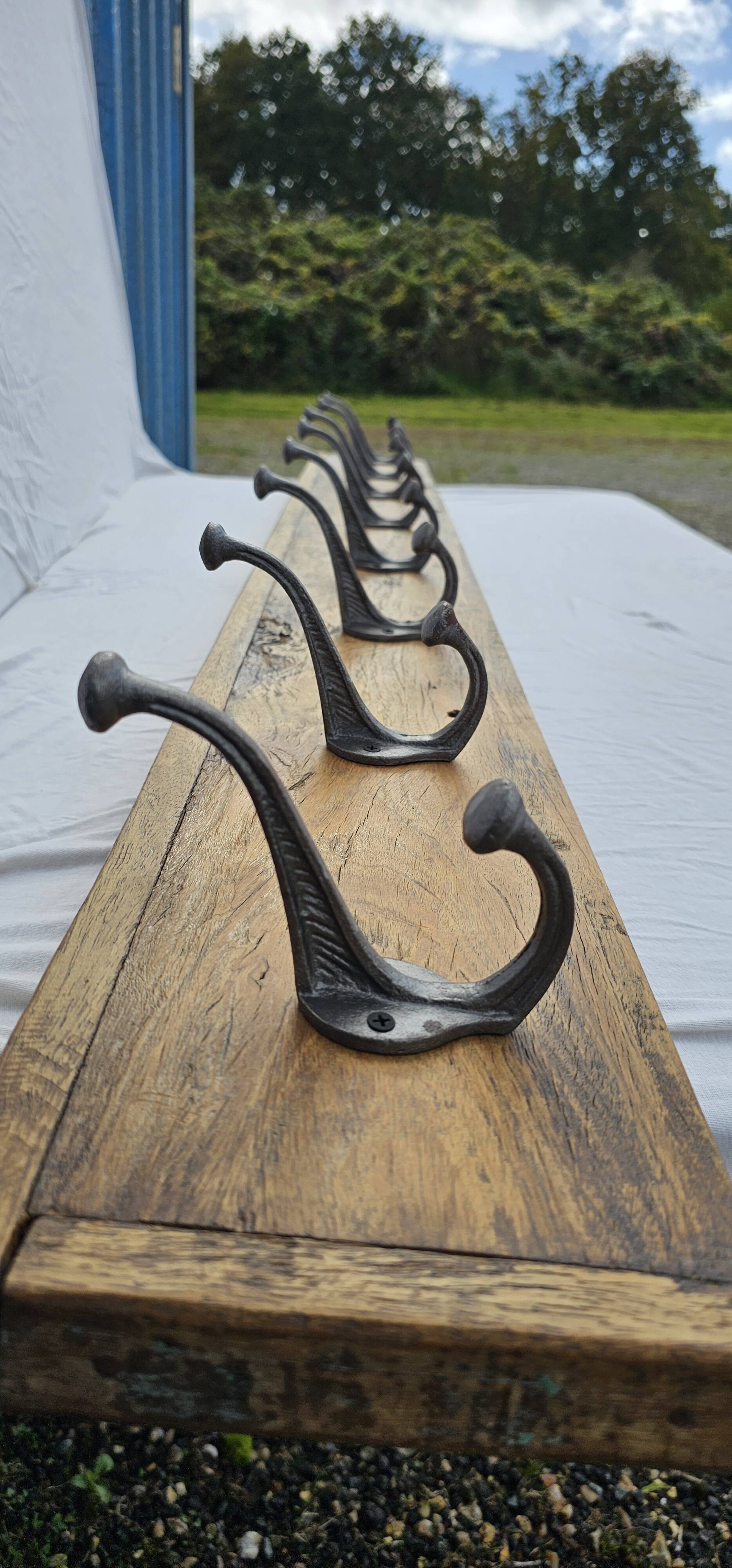 Teak coat rack with 8 double cast iron hooks