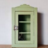 Small glass cabinet in green colour.