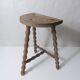 vintage half-moon tripod stool in turned solid wood with beaded edges