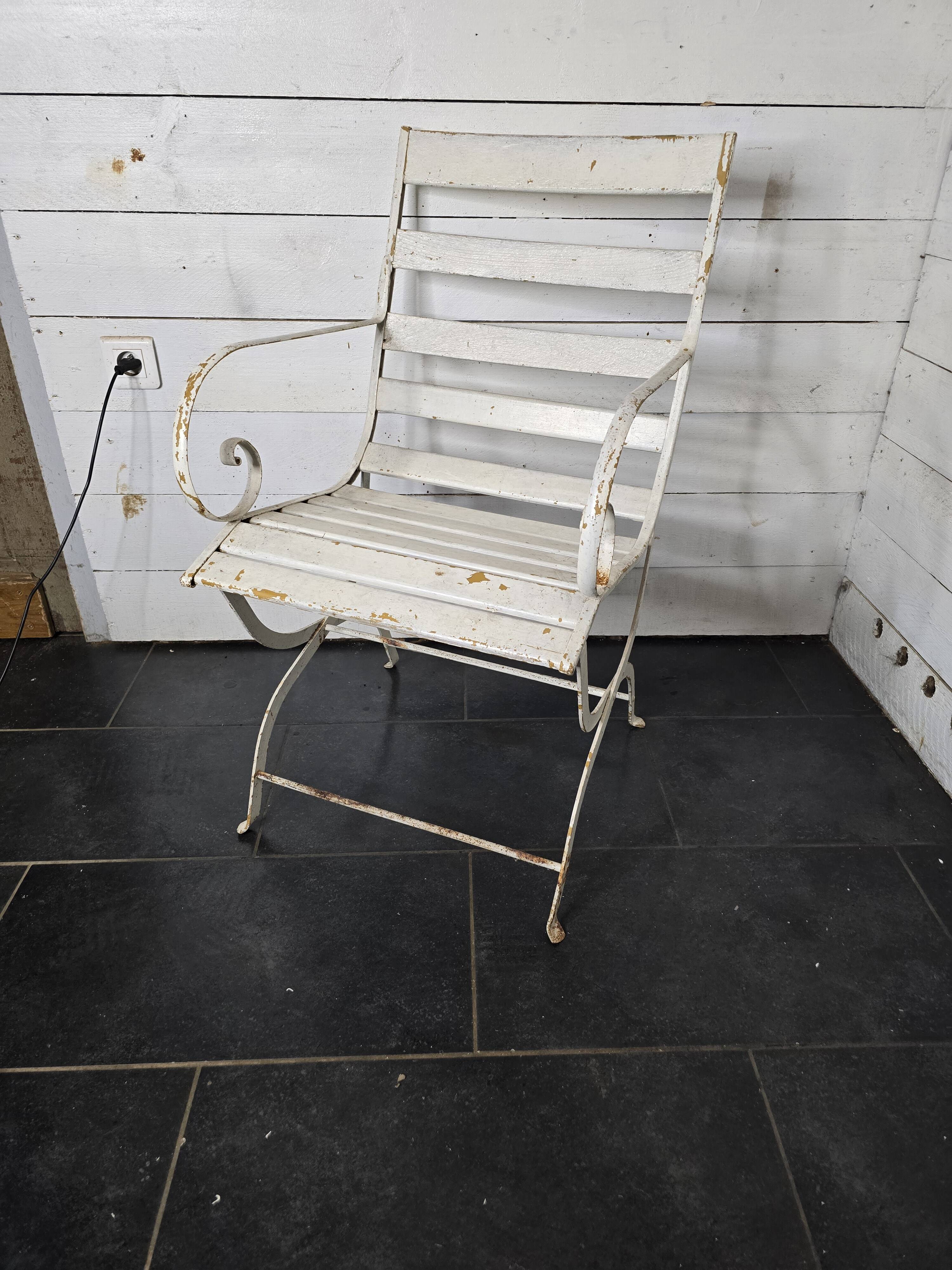 Old wrought iron and wood garden armchair