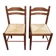 2 square wooden kitchen chairs with straw seats.