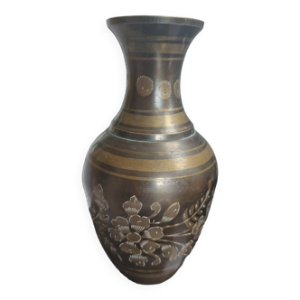 Metal vase with chiseled patterns