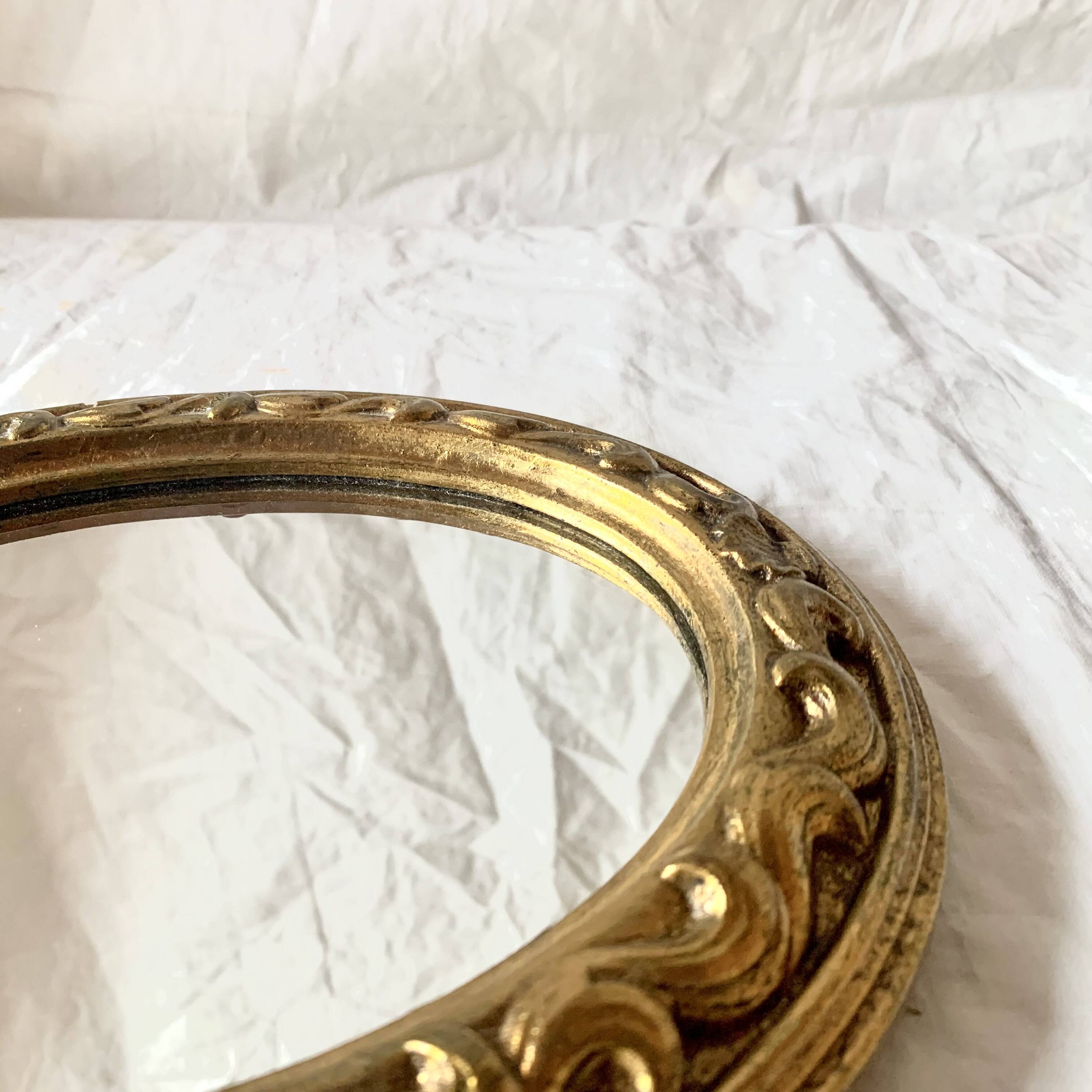 Small vintage wall mirror in gold resin