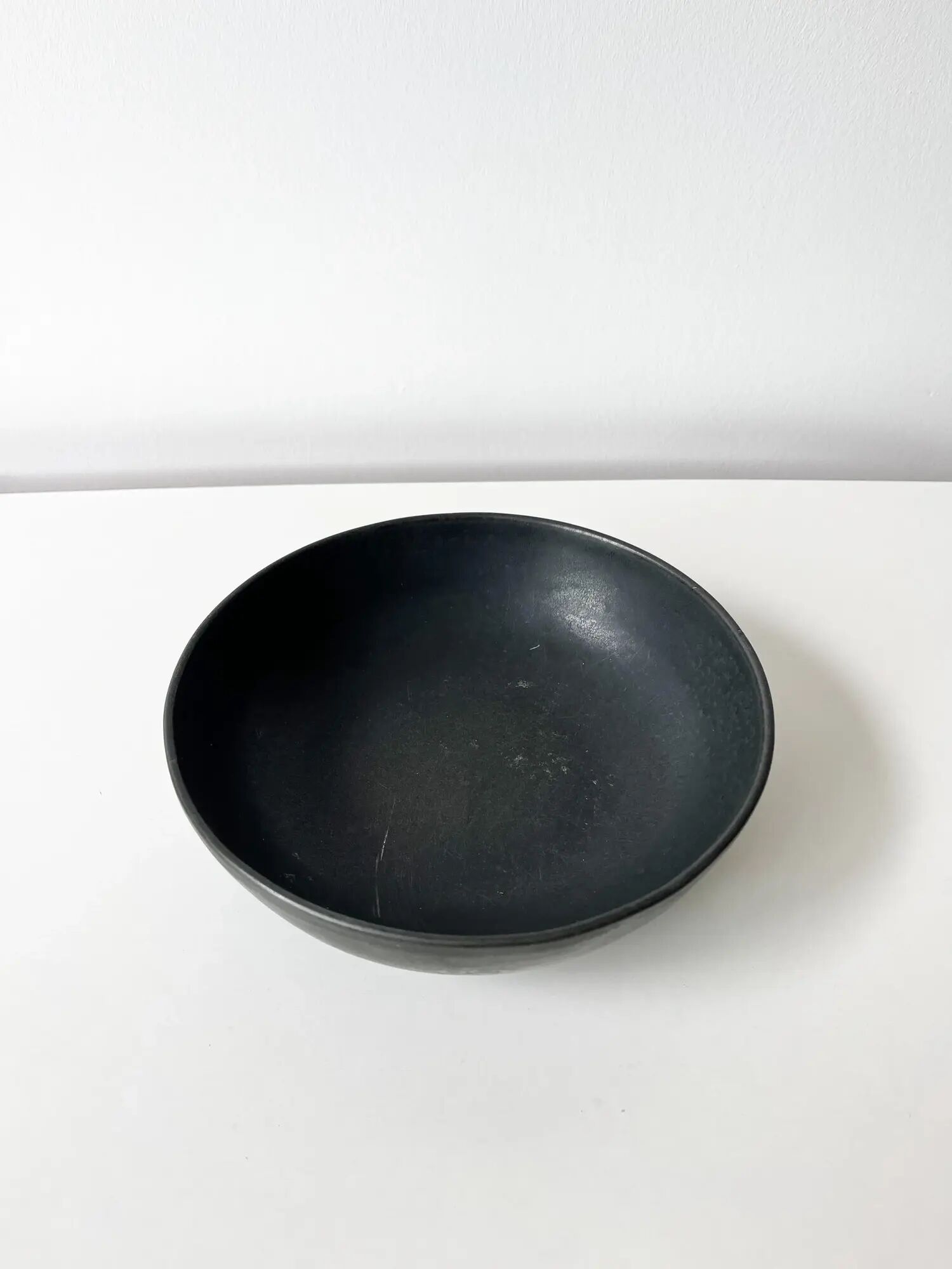 Round vintage black ceramic catchall.