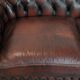 Classic cowhide Chesterfield sofa in English style with red/brown colours