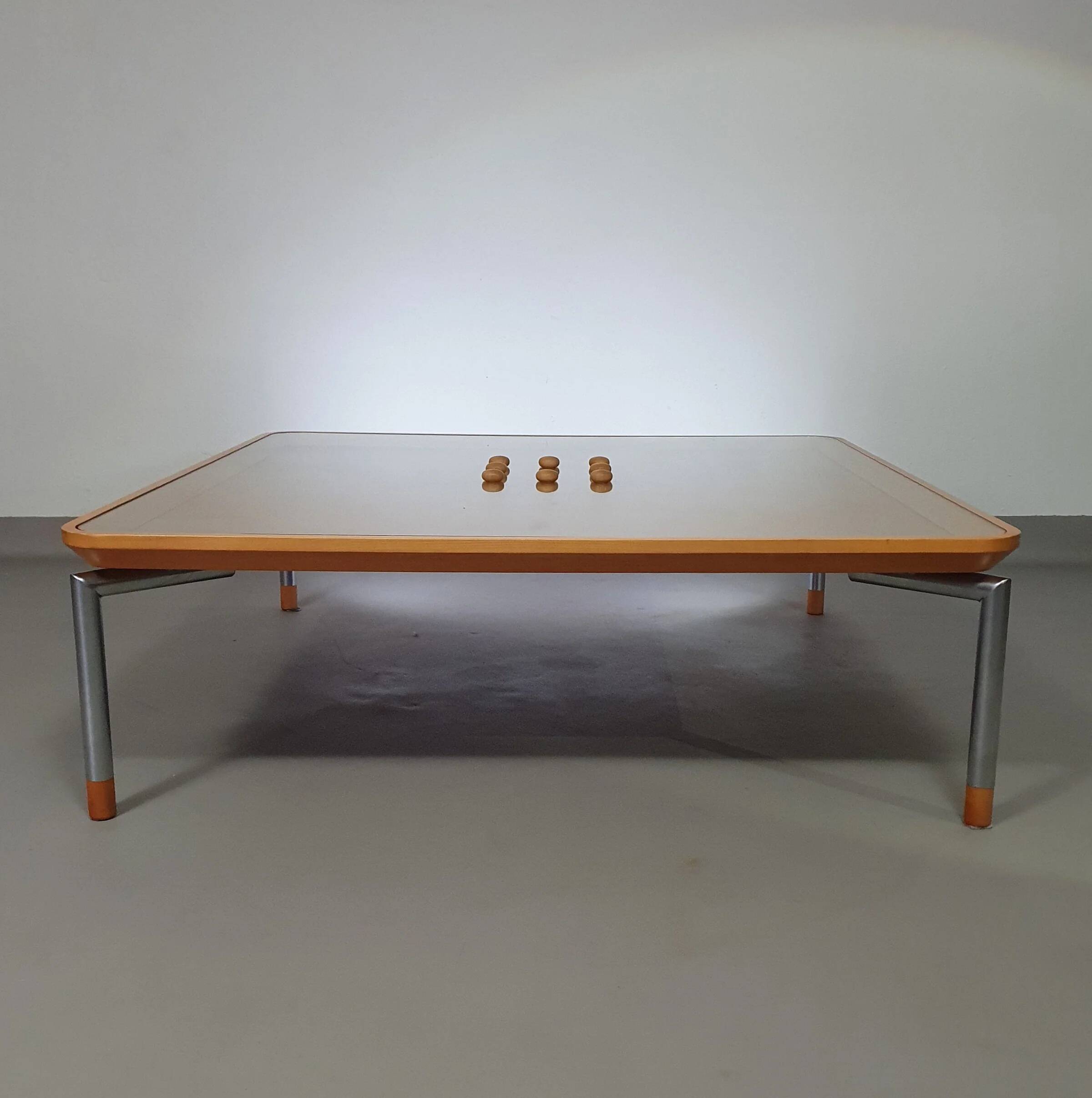 Rare coffee table 110 x 110 x height 35 cm with 8 flange wooden / cork caps in the glass top.