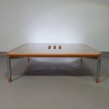 Rare coffee table 110 x 110 x height 35 cm with 8 flange wooden / cork caps in the glass top.