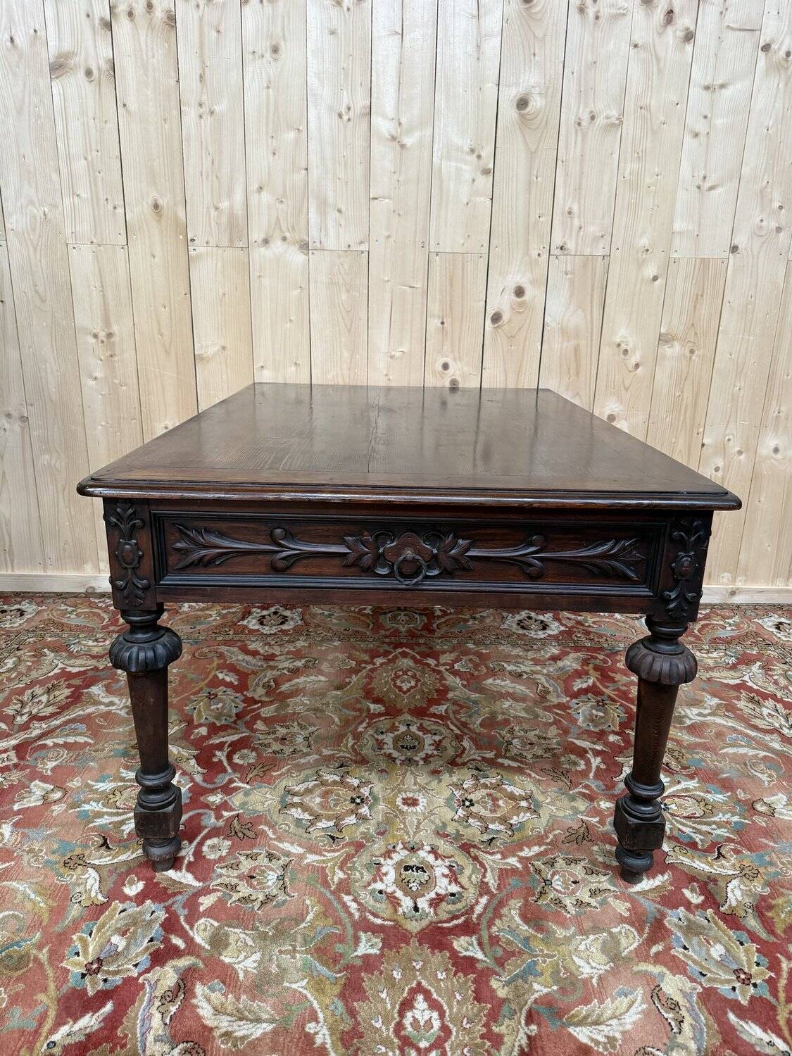 Middle table in a sculpted Louis XIII style living room.
