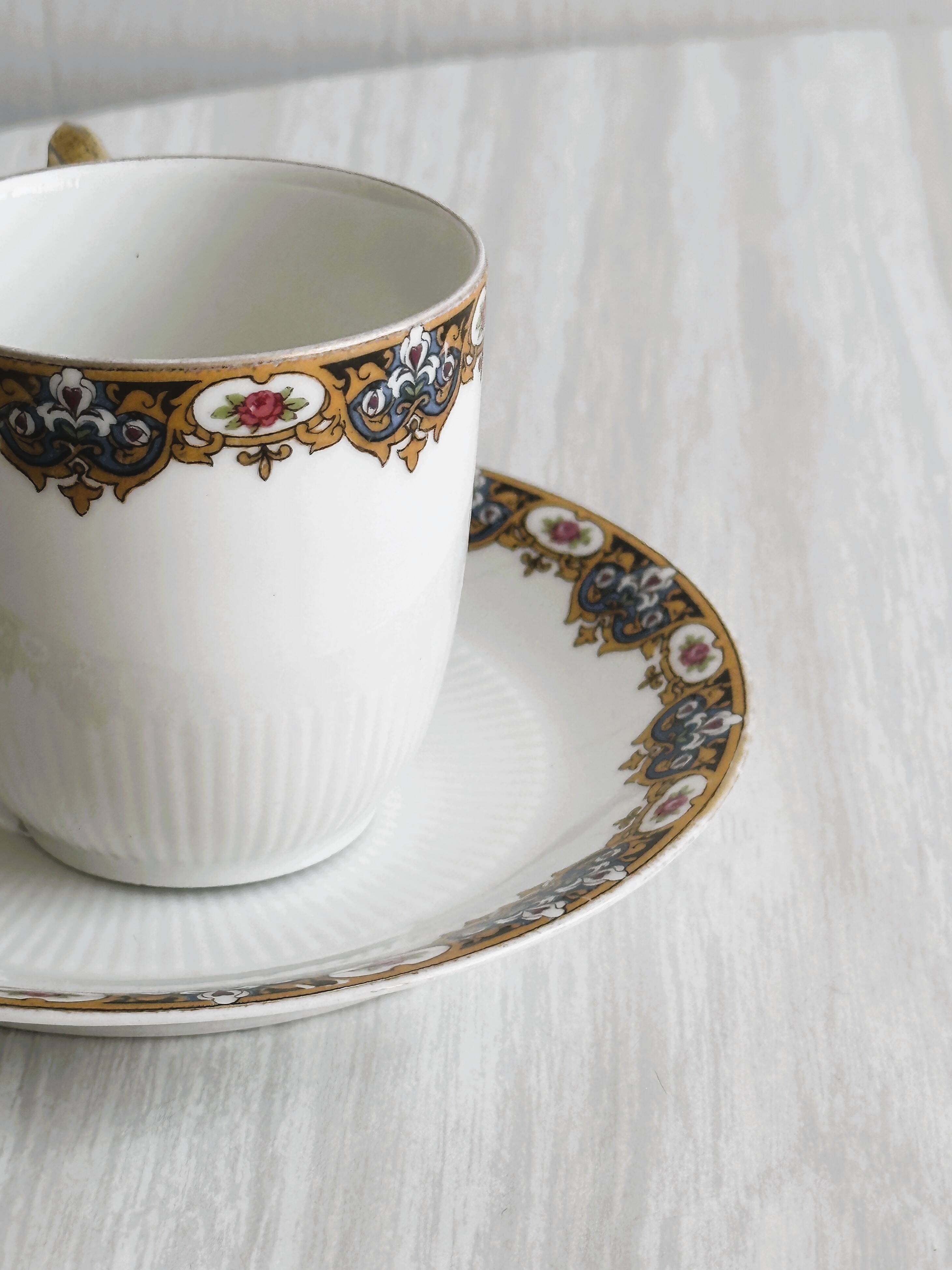 7 Limoges porcelain cups and saucers with gold decoration and floral motif.