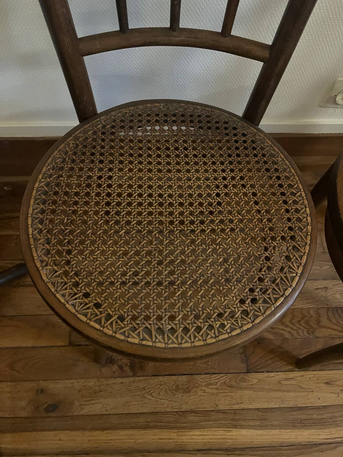 Pair of antique caned bistro chairs stamped Fischel