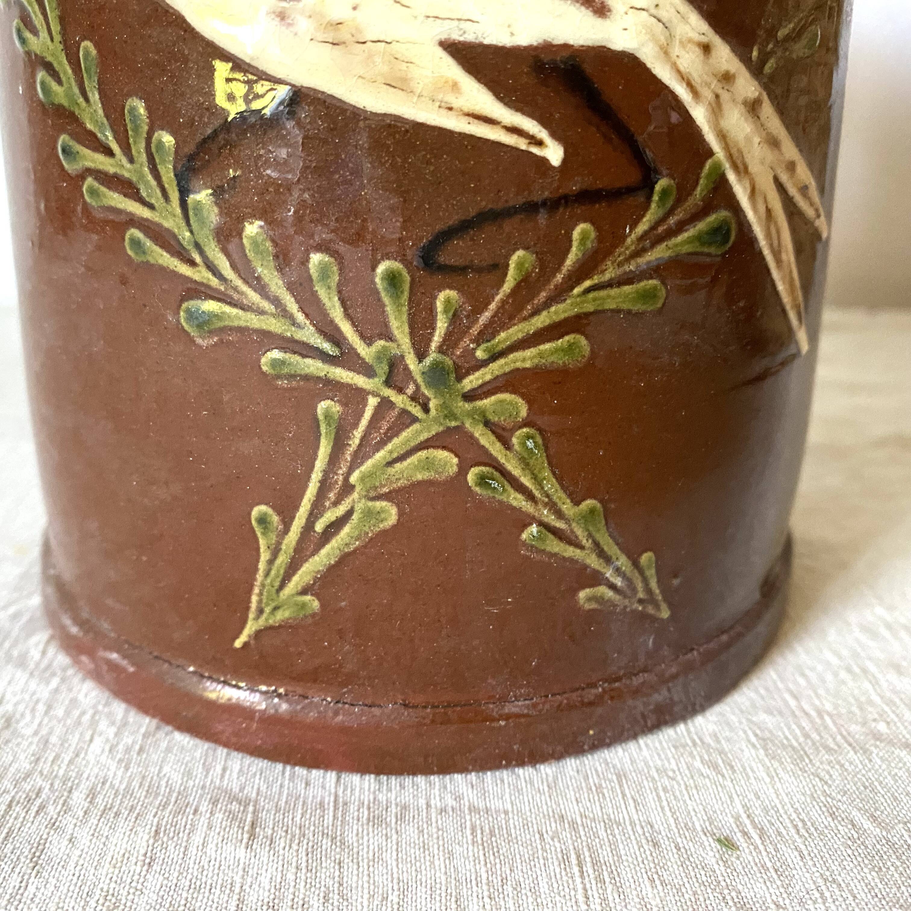 Terracotta pitcher with hand-painted bird decor