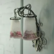 Wall lamp in wrought iron with a pink tulip glass globe by Muller glassworks.