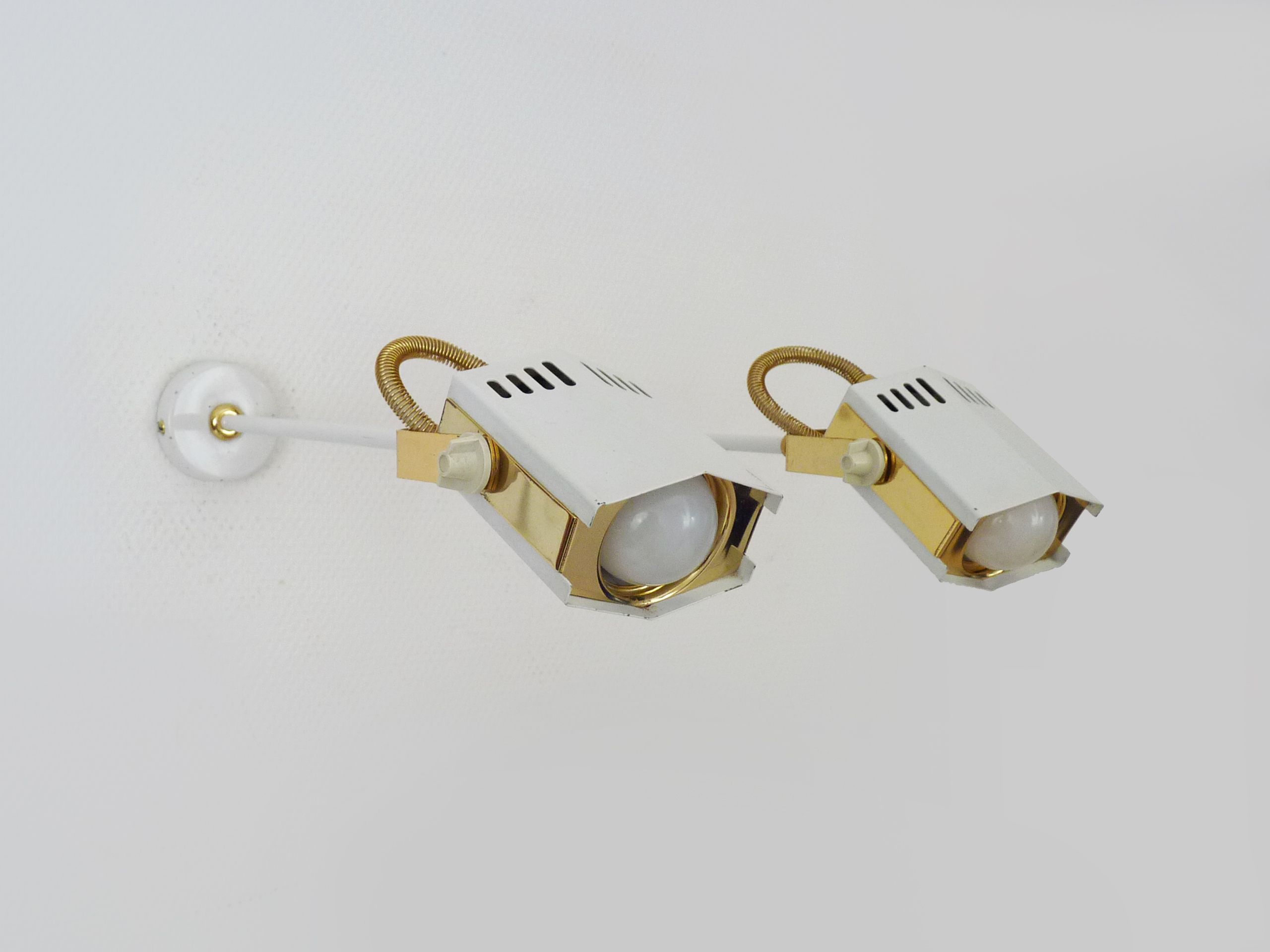 Pair of spot wall lamps adjustable design in white metal and brass. Year 80