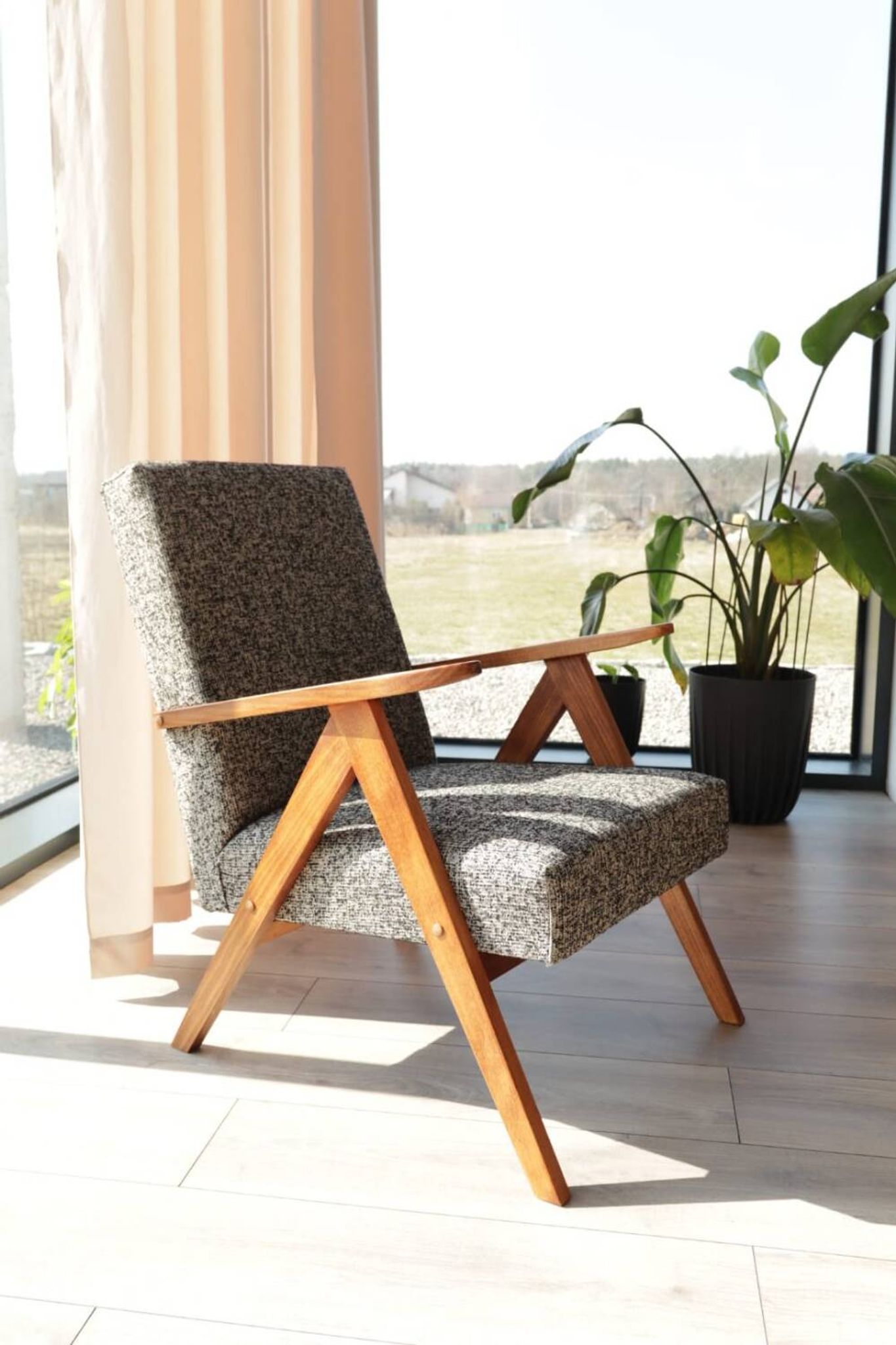 Vintage design armchair in mixed black fabric, walnut-coloured wood.