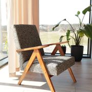 Vintage design armchair in mixed black fabric, walnut-coloured wood.