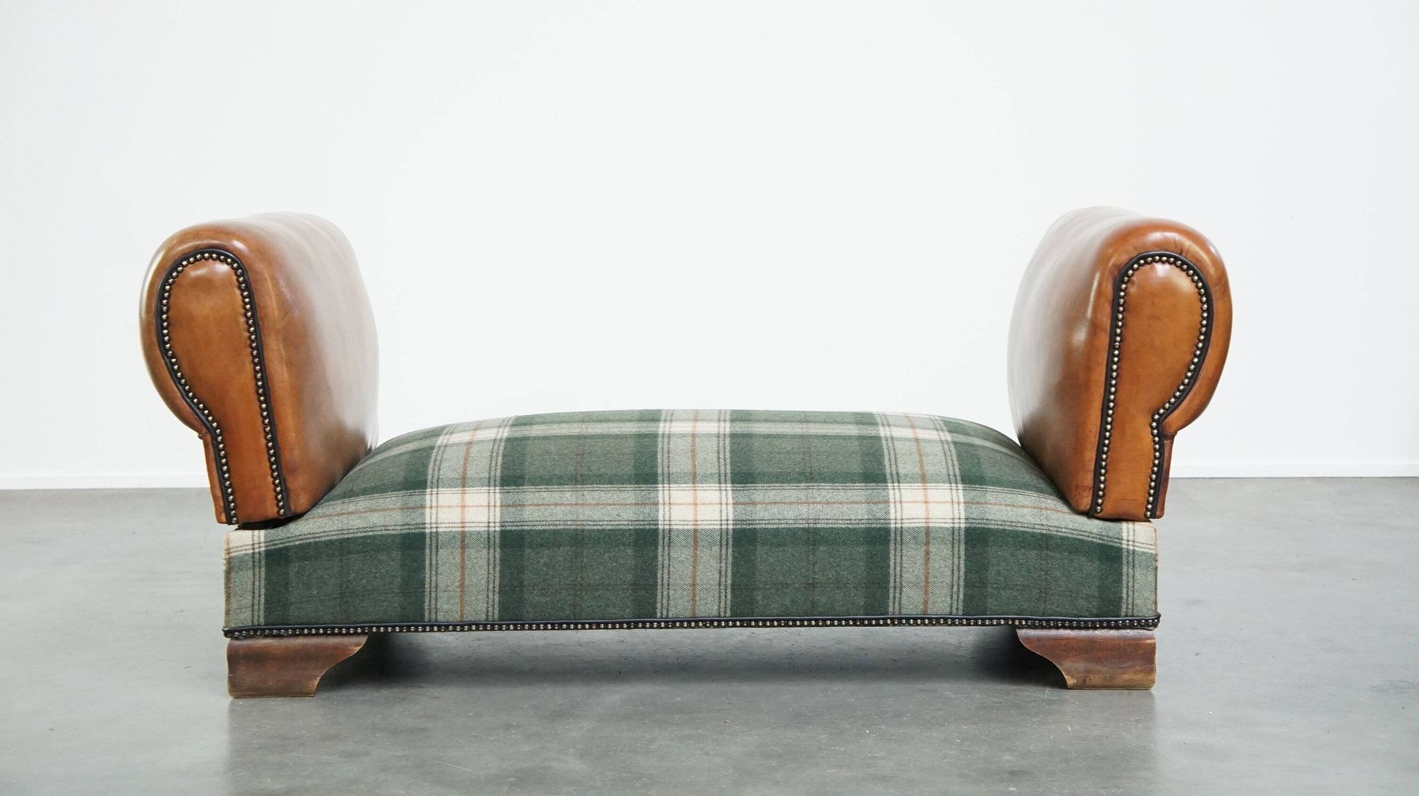Antique daybed reupholstered with sheepskin and Scottish tartan wool