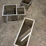 Set of coffee tables, pedestal tables and nesting tables in smoked glass and metal