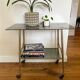 Vintage brass and smoked glass dessert trolley on wheels.