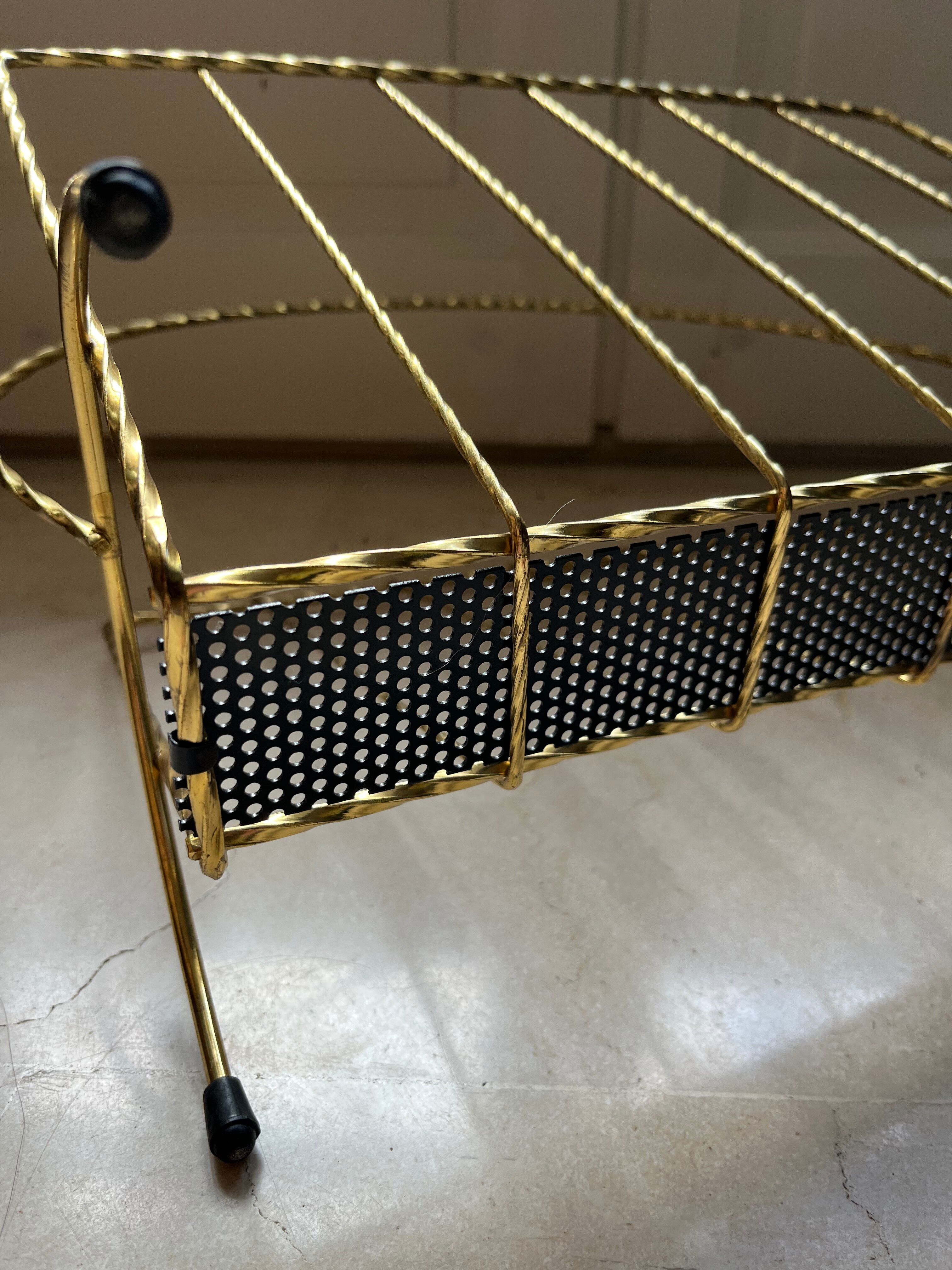 Vintage gold metal magazine rack from the 1960s.