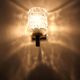 Pair of wall sconces in textured glass, wood, and gold metal, 1970.