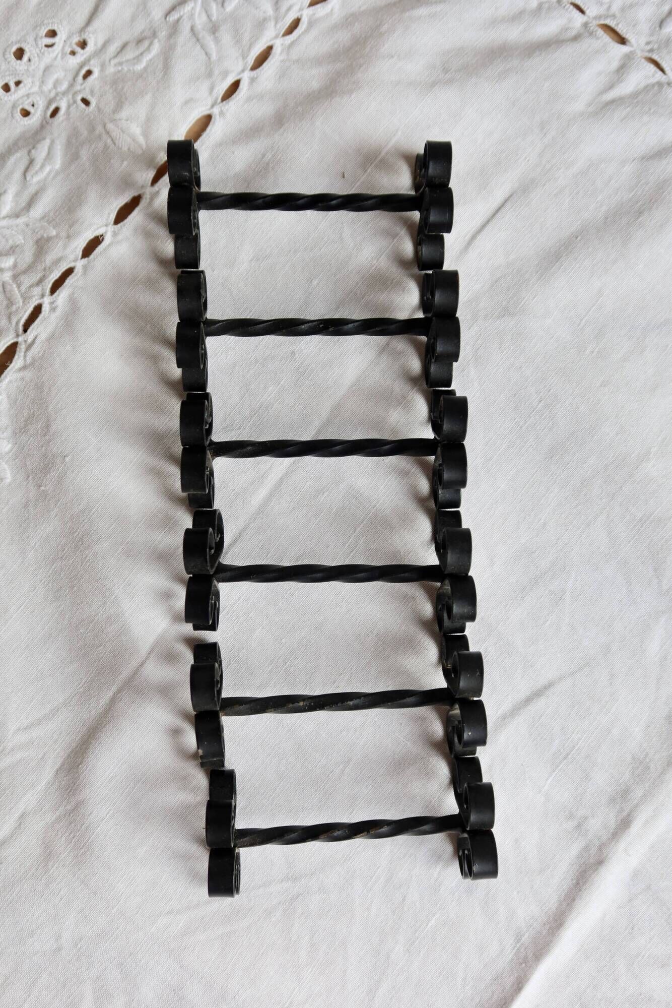 6 vintage black metal knife rests with scroll decorations