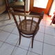 Curved wooden chair, turned and seated in cannage