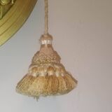 Oval mirror in wood and gilded plaster with pompom decoration