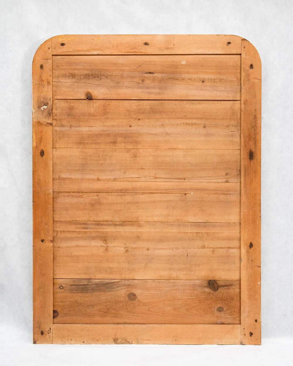 19th-century patinated mirror with a ribbon-style frame