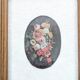 Vintage floral print with oval mat and gold wooden frame.