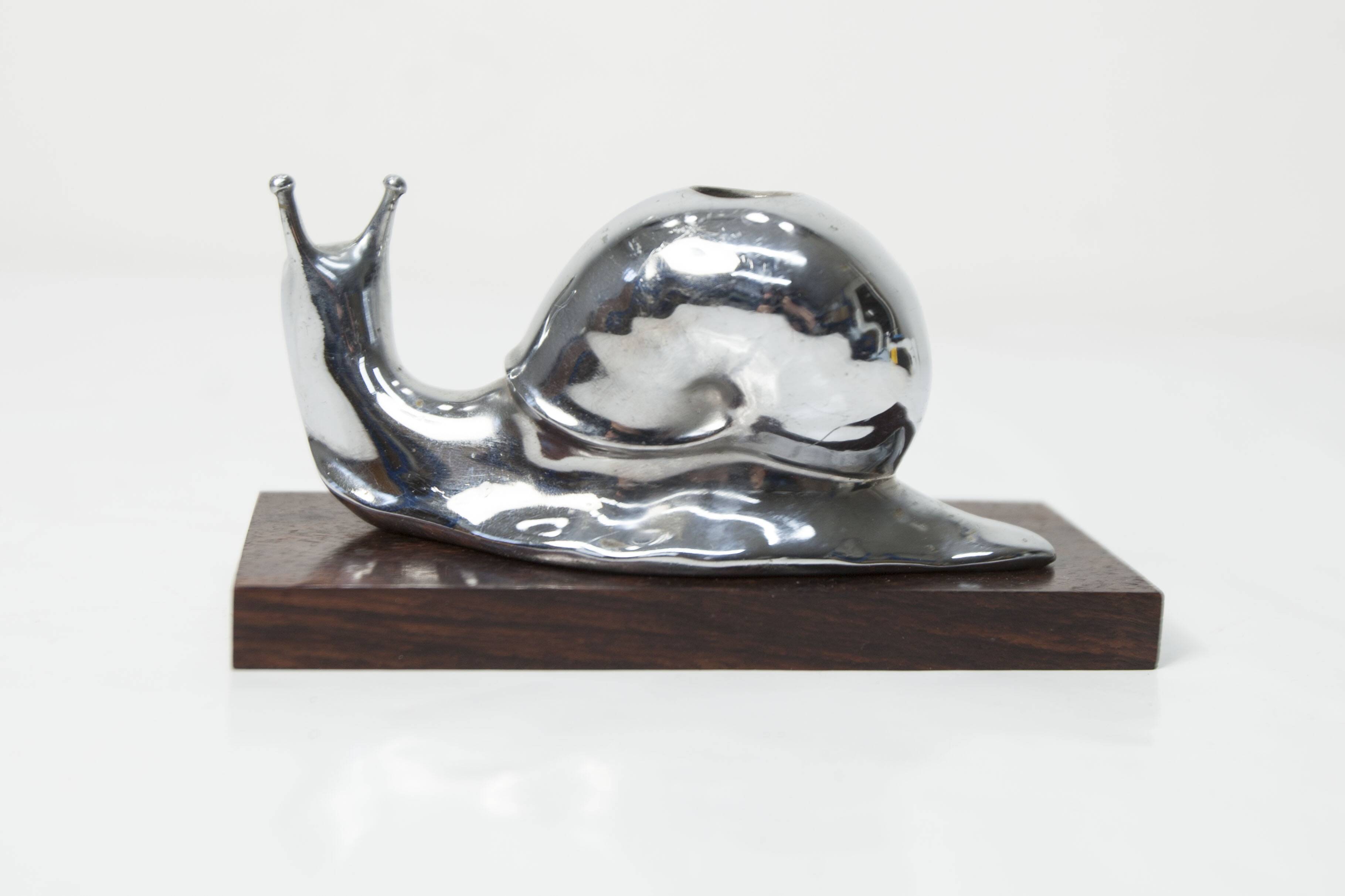 Silver snail candlestick on a teak base 1960